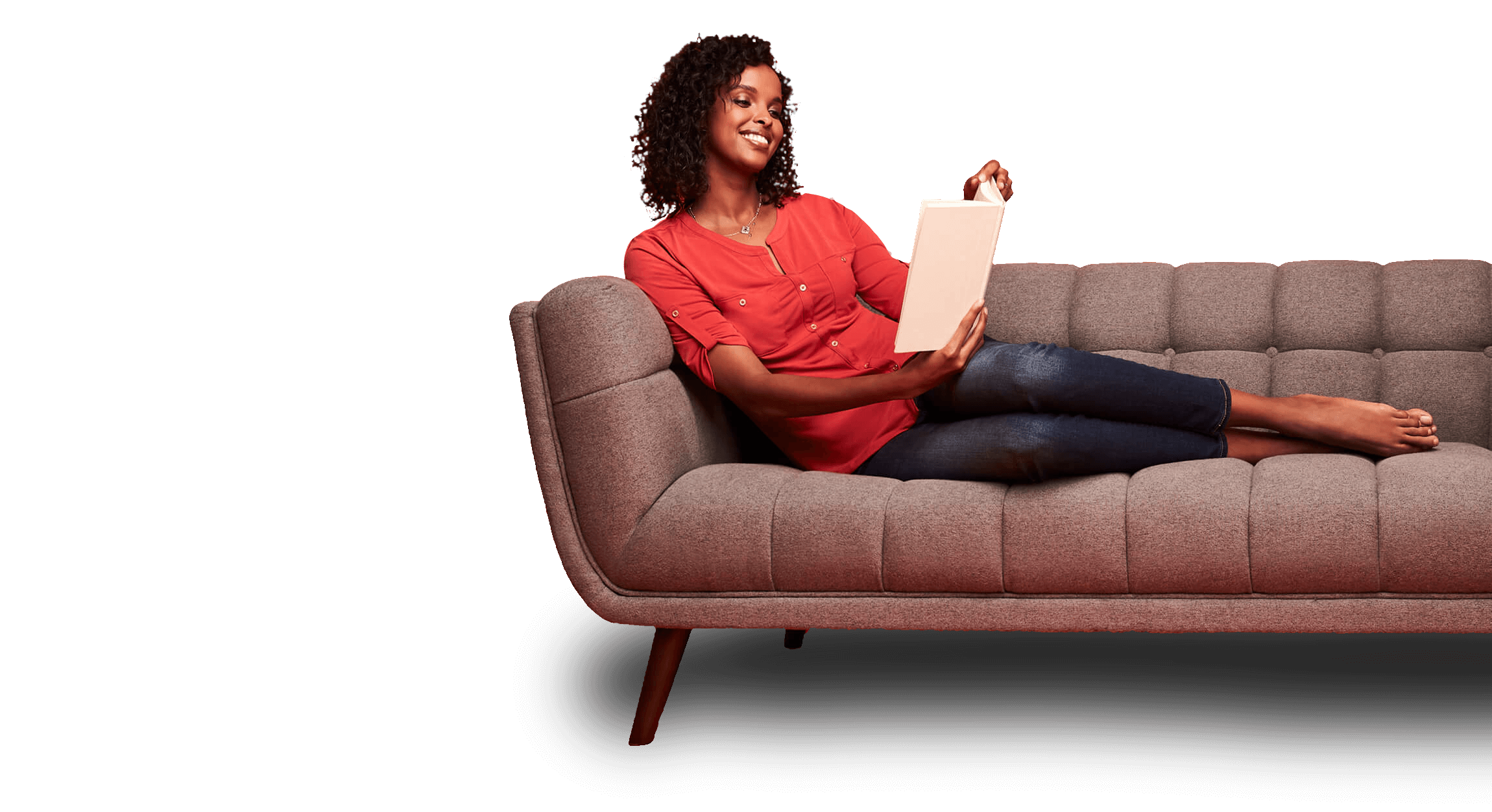 Woman sitting on a couch reading Woman sitting on a couch reading