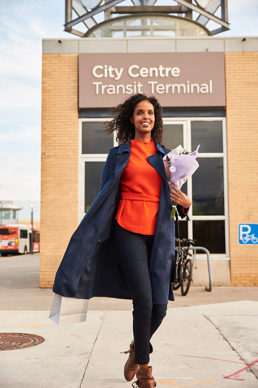 Woman walking past City Centre Transit Terminal Woman walking past City Centre Transit Terminal